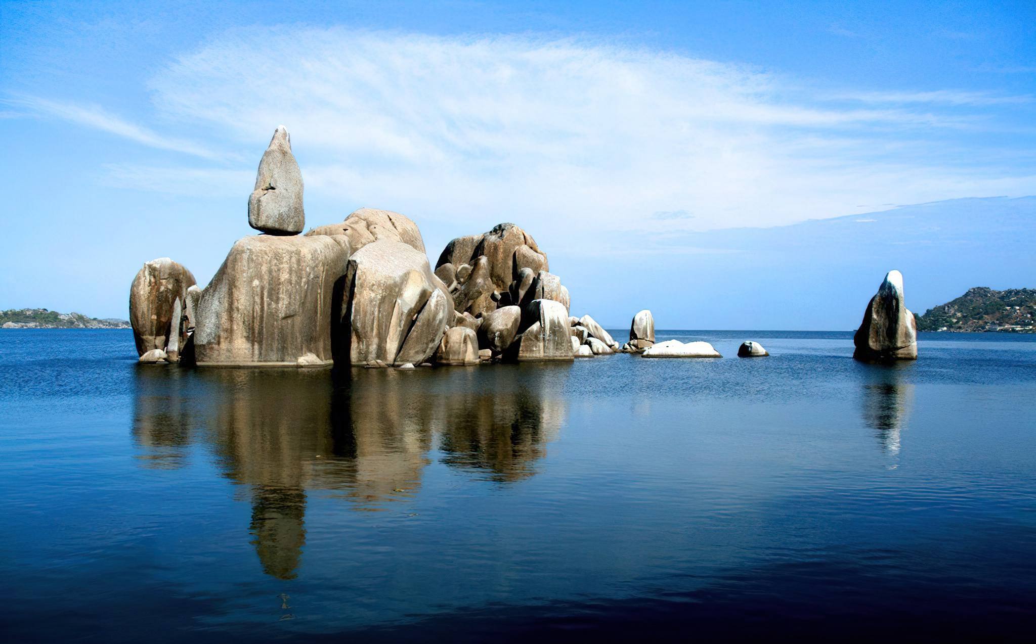Rocky island formations in calm Lake Victoria water